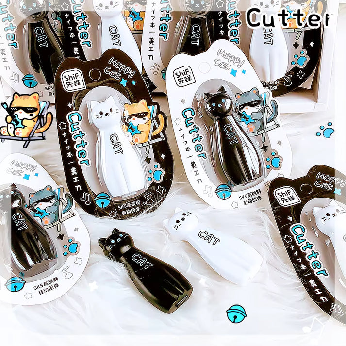 Miso station Happy Cat retractable utility cutters in black and white with ergonomic cat-shaped designs.