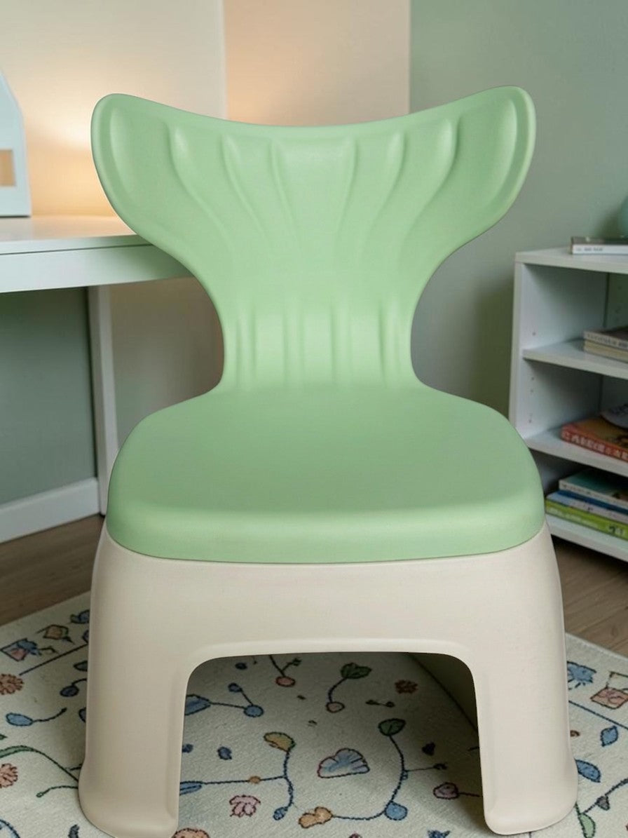 Miso station ergonomic toddler chair in sage green and beige with a whimsical mermaid tail backrest in a playroom.