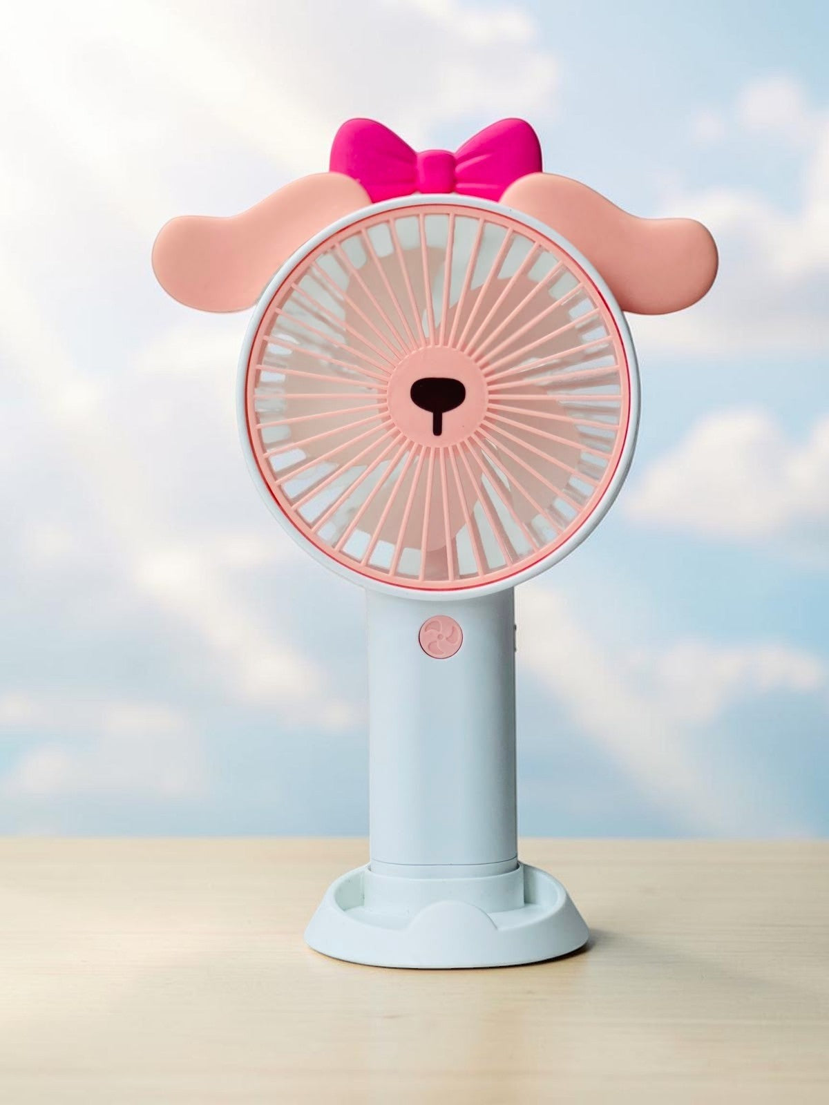 Miso station portable animal-shaped handheld desk fan in pastel blue and pink with a cute bow and phone stand base.