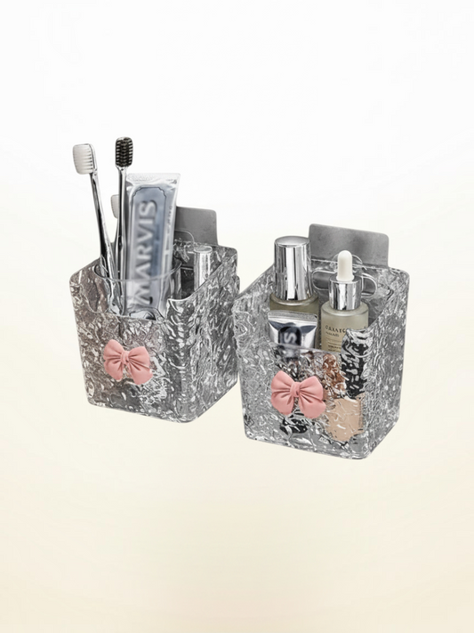 Miso station wall-mounted clear acrylic bathroom organizers with textured glass finish and pastel pink bow accents.