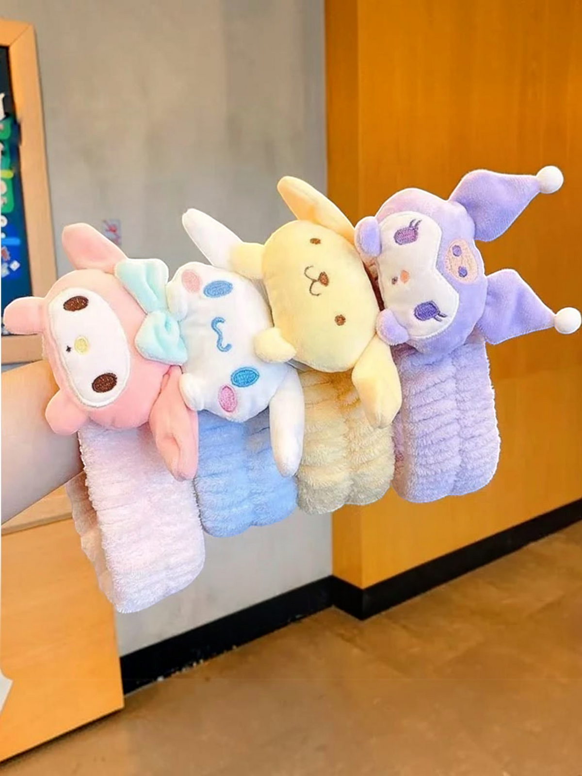 Miso station Korean facial headbands featuring soft plush Sanrio character designs in pink, blue, yellow, and purple.