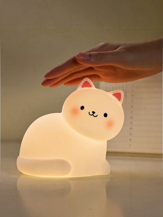 Miso station rechargeable kitty night lamp with soft warm glow and cute feline design on a bedside table