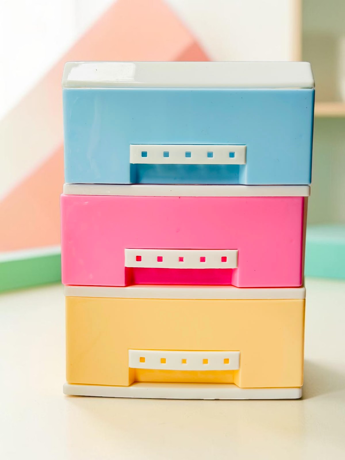 Miso station 3-tier desktop plastic storage drawer organizer with blue, pink, and yellow drawers on a white surface.