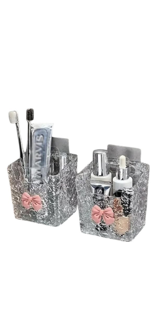 Miso station wall-mounted clear acrylic bathroom organizers with textured glass finish and pastel pink bow accents.