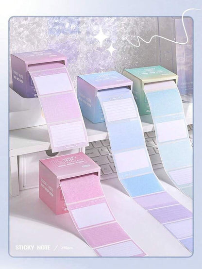 Miso station adhesive note roll dispensers in pastel gradient colors with pull-out paper sheets on a desk