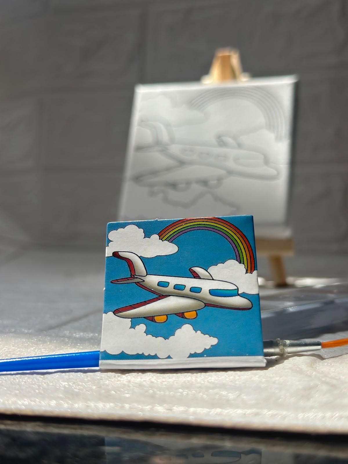 Miso station airplane painting kit with a small canvas, wooden easel, paint brush, and colorful airplane design.