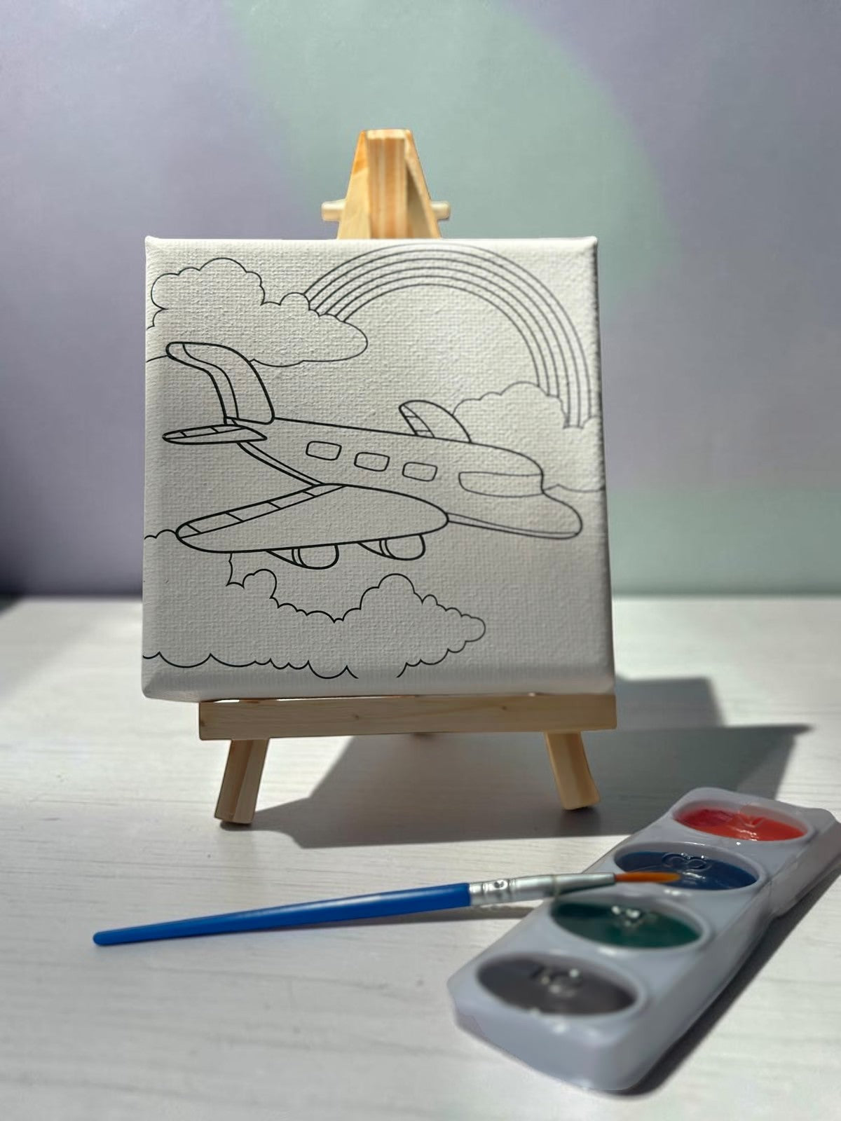 Miso station airplane painting kit with pre-printed canvas, wooden easel, paint palette, and brush for kids.