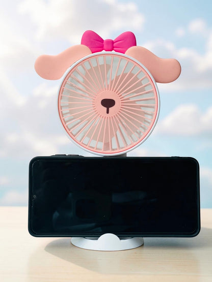 Miso station portable animal handheld desk fan in pastel pink with floppy ears, a pink bow, and phone stand base.