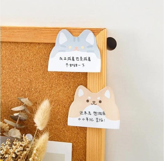 Miso station cat and dog shaped adhesive memo pads stuck to a cork board for desk organization