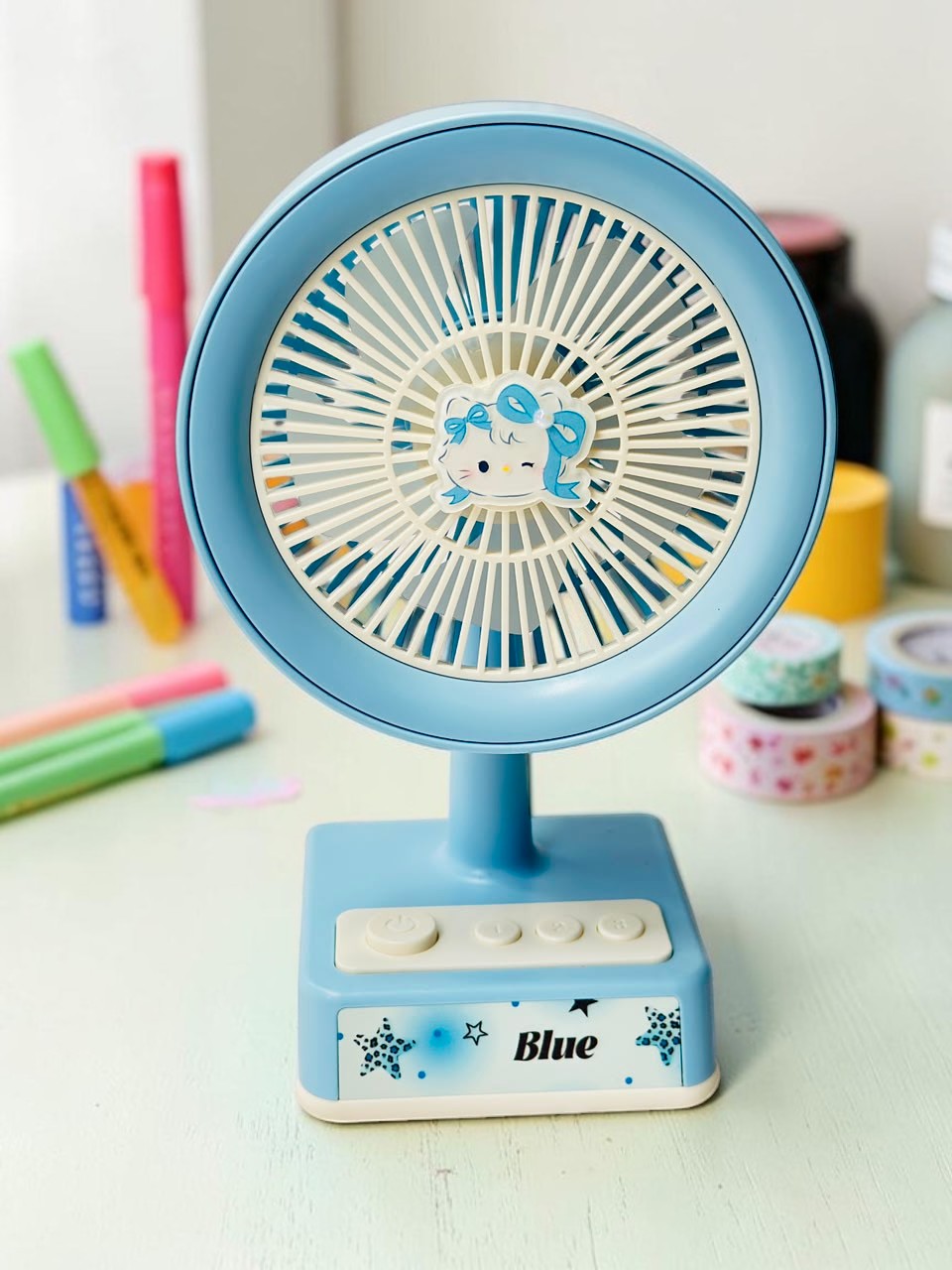 Miso station pastel blue portable desk fan with a cute cartoon character centerpiece and USB power button controls.