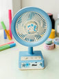 Miso station pastel blue portable desk fan with a cute cartoon character centerpiece and USB power button controls.