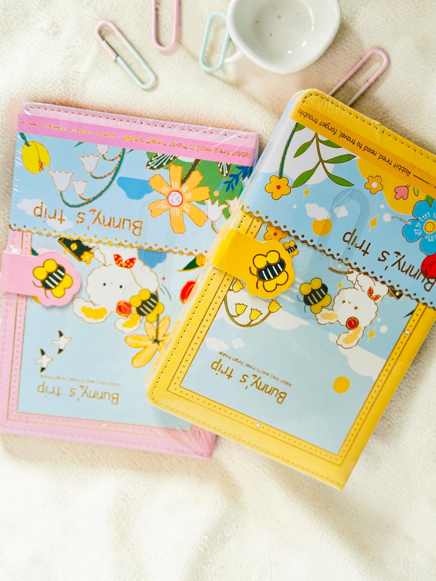 Miso station Bunny Trip journals in pink and yellow with whimsical bunny illustrations and bee magnetic clasps.