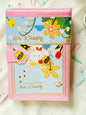 Miso station Bunny Trip journal with a pink cover, whimsical bunny and garden illustration, and a bee magnetic clasp.