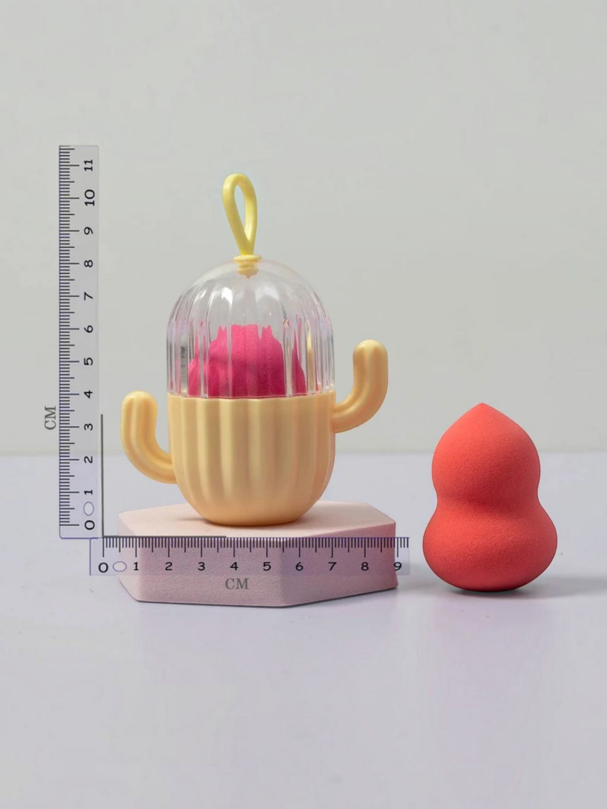 Miso station cactus-shaped makeup sponge holder with a clear vented lid and a pink beauty blender on a display base
