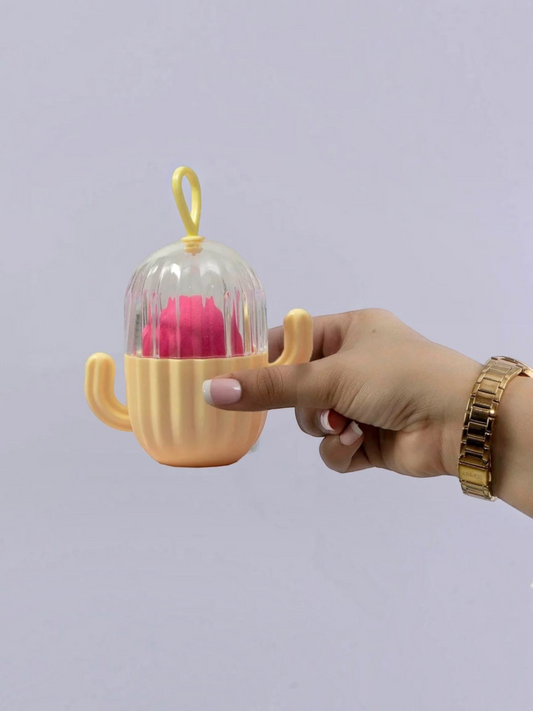 Miso station cactus-shaped makeup sponge holder with a clear vented lid and a pink beauty blender inside