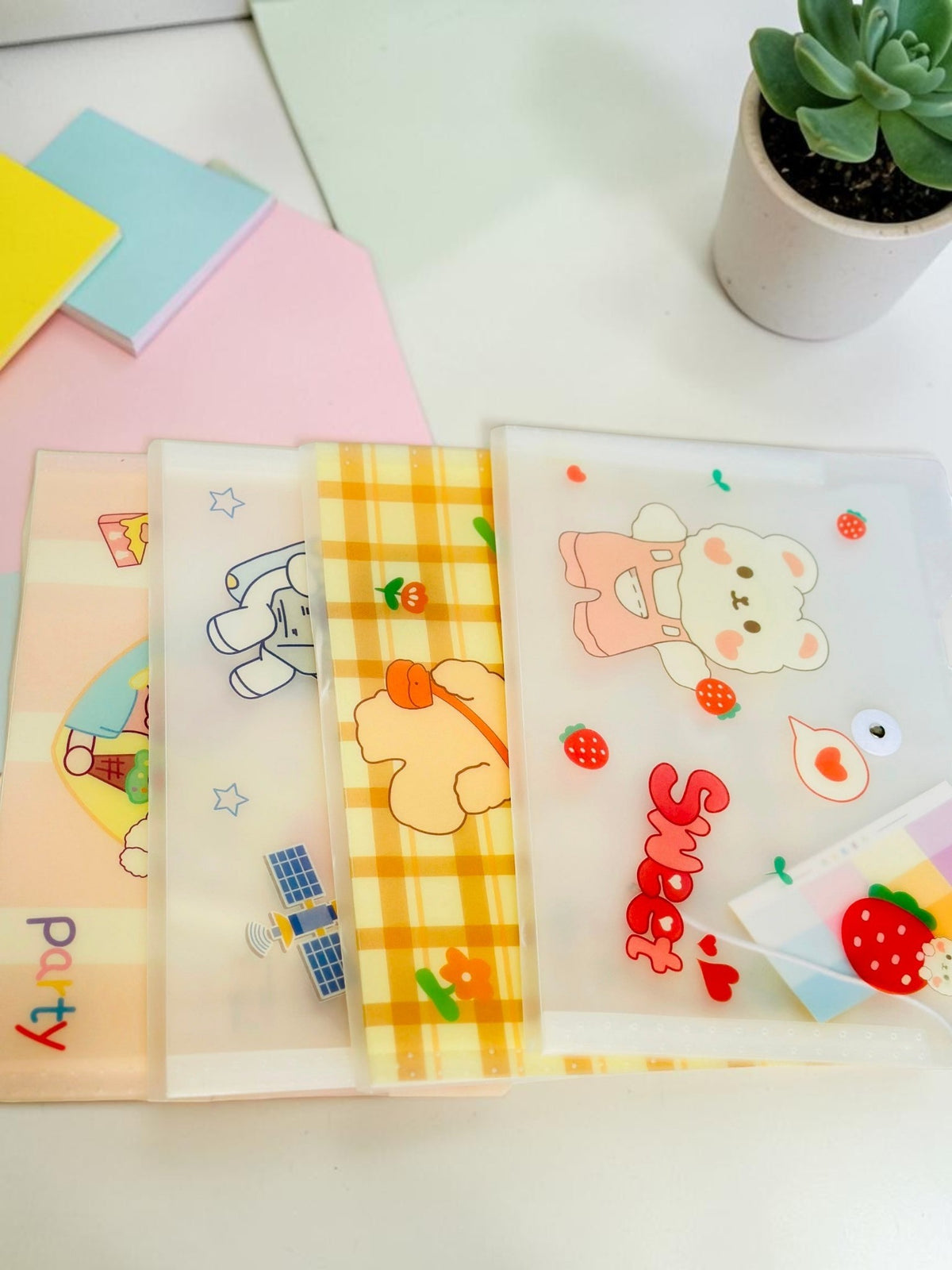 Miso station frosted plastic A4 document folders with cute cartoon bear, strawberry, and space-themed illustrations.