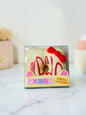 Miso station cat ear donut stress relief toy in clear packaging with red icing and a red bow on a white background