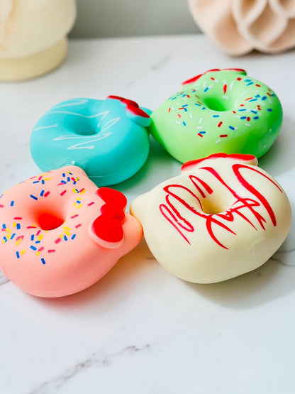 Miso station cat ear donut squeeze toys in pink, blue, green, and white with red bows and colorful sprinkles