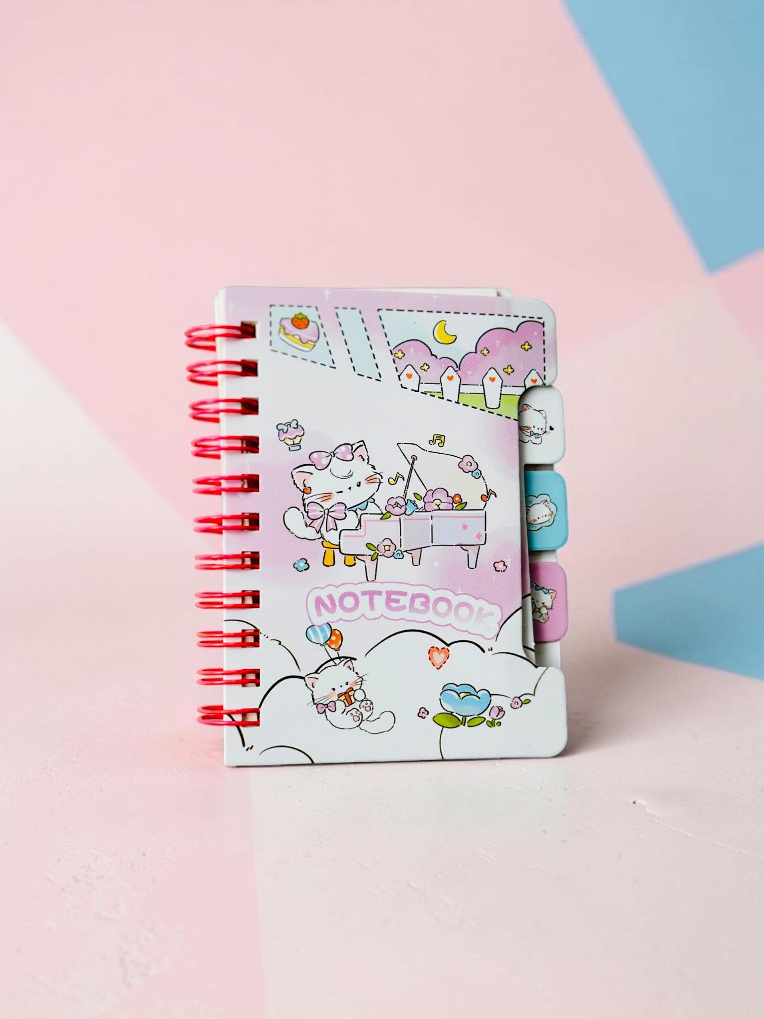 Miso station spiral bound notebook featuring cute cartoon kittens playing piano in a pastel pink garden setting