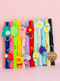 Miso station colorful gel pens with 3D silicone animal and food charms like dinosaurs, ducks, and fruit on a pink background