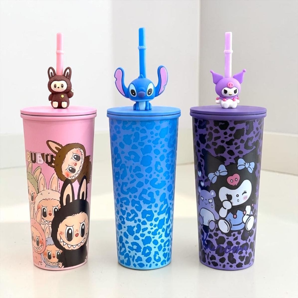 Miso station character themed insulated tumblers with 3D toppers, reusable straws, and vibrant leopard print designs.