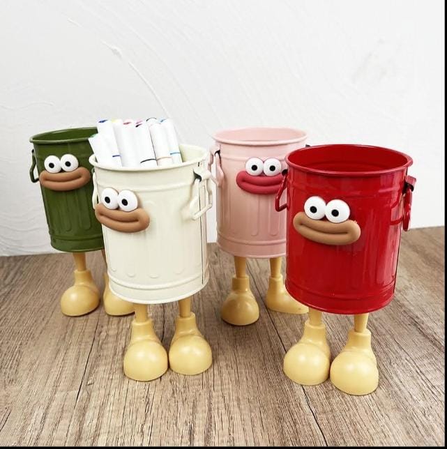 Miso station whimsical character pen holders in olive, cream, pink, and red with expressive faces and playful legs.