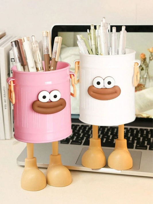 Miso station pink and white cartoon character pen holders with expressive faces and playful legs on a desk
