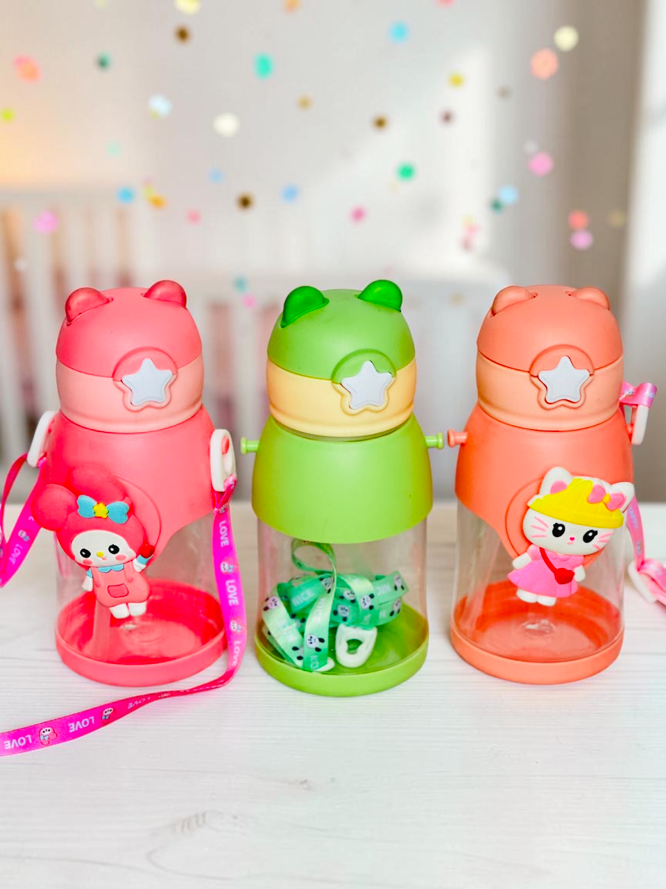 Miso station character-themed water bottles in pink, green, and coral with 3D animal accents and carrying straps.