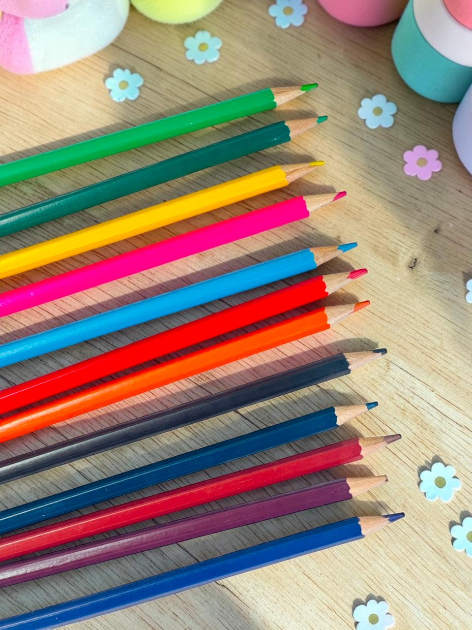 Miso station set of 12 vibrant colored pencils with smooth leads arranged on a wooden desk with floral accents
