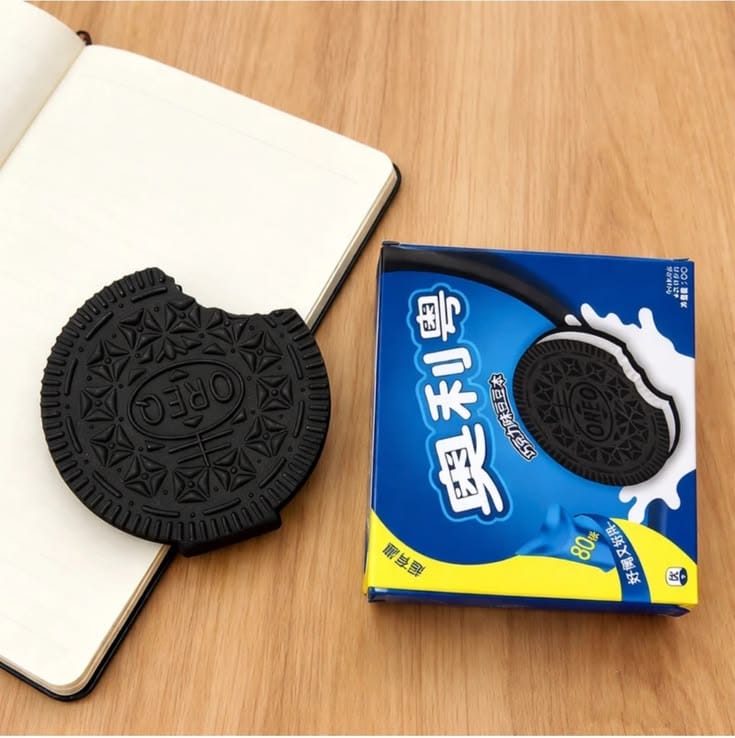 Miso station cookie-shaped rubber eraser next to its blue packaging on a wooden desk surface.