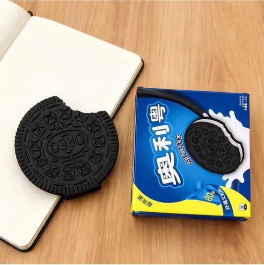 Miso station cookie-shaped rubber eraser next to its blue packaging on a wooden desk surface.