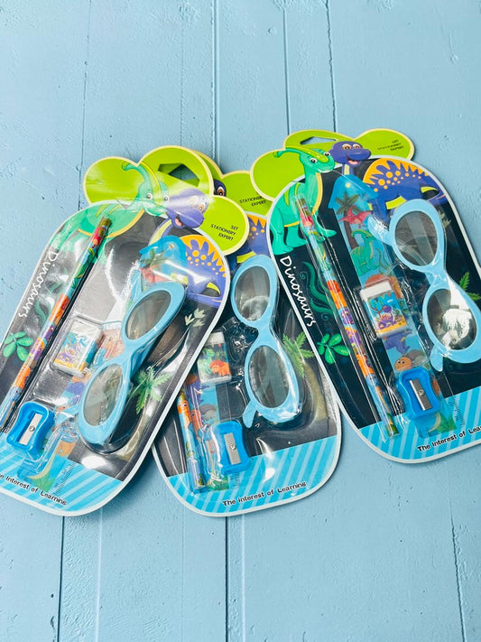 Miso station dinosaur stationery set featuring a pencil, eraser, sharpener, ruler, and light blue novelty glasses.