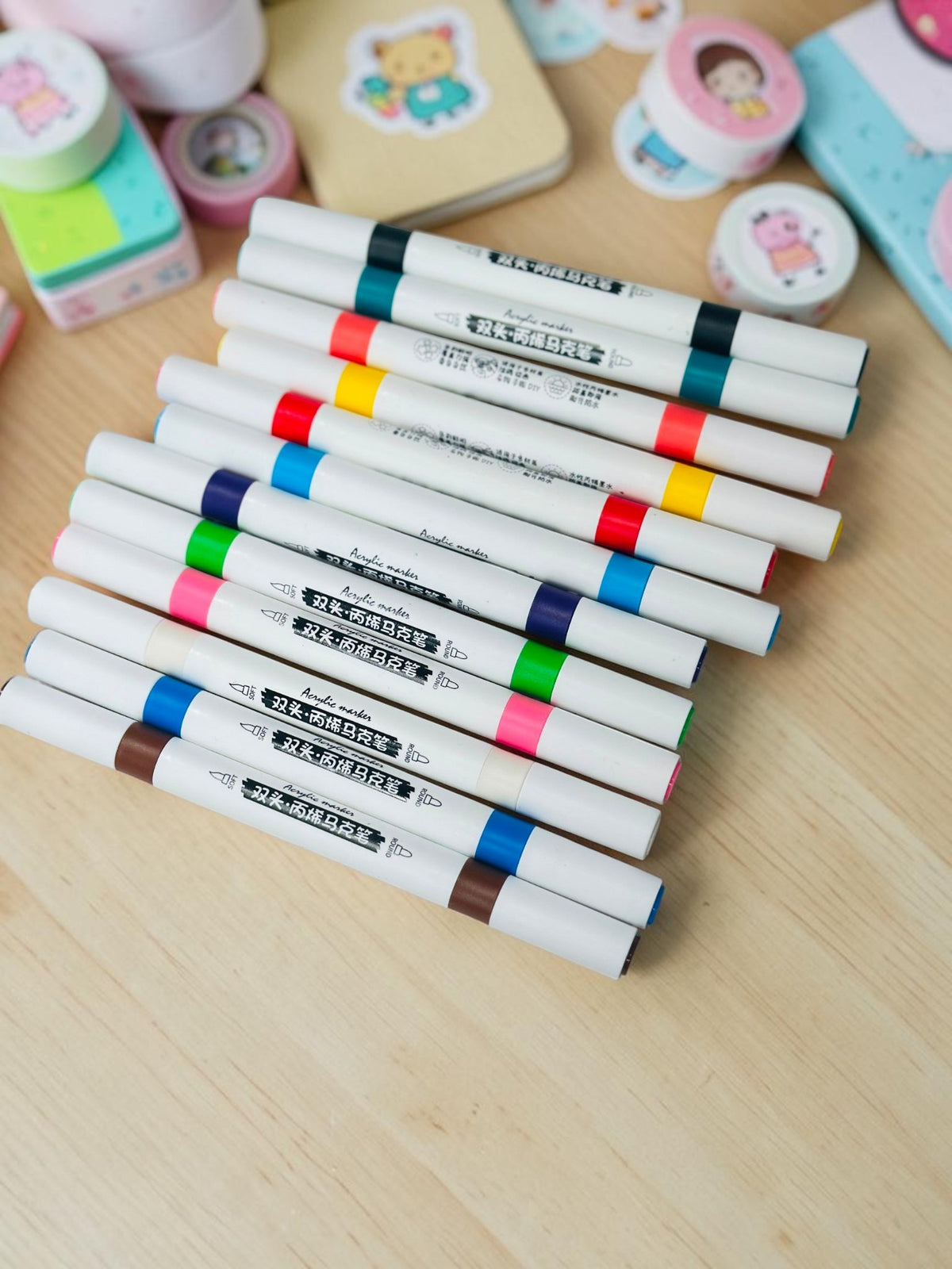 Miso station dual tip acrylic paint markers in a variety of vibrant colors on a white textured background.