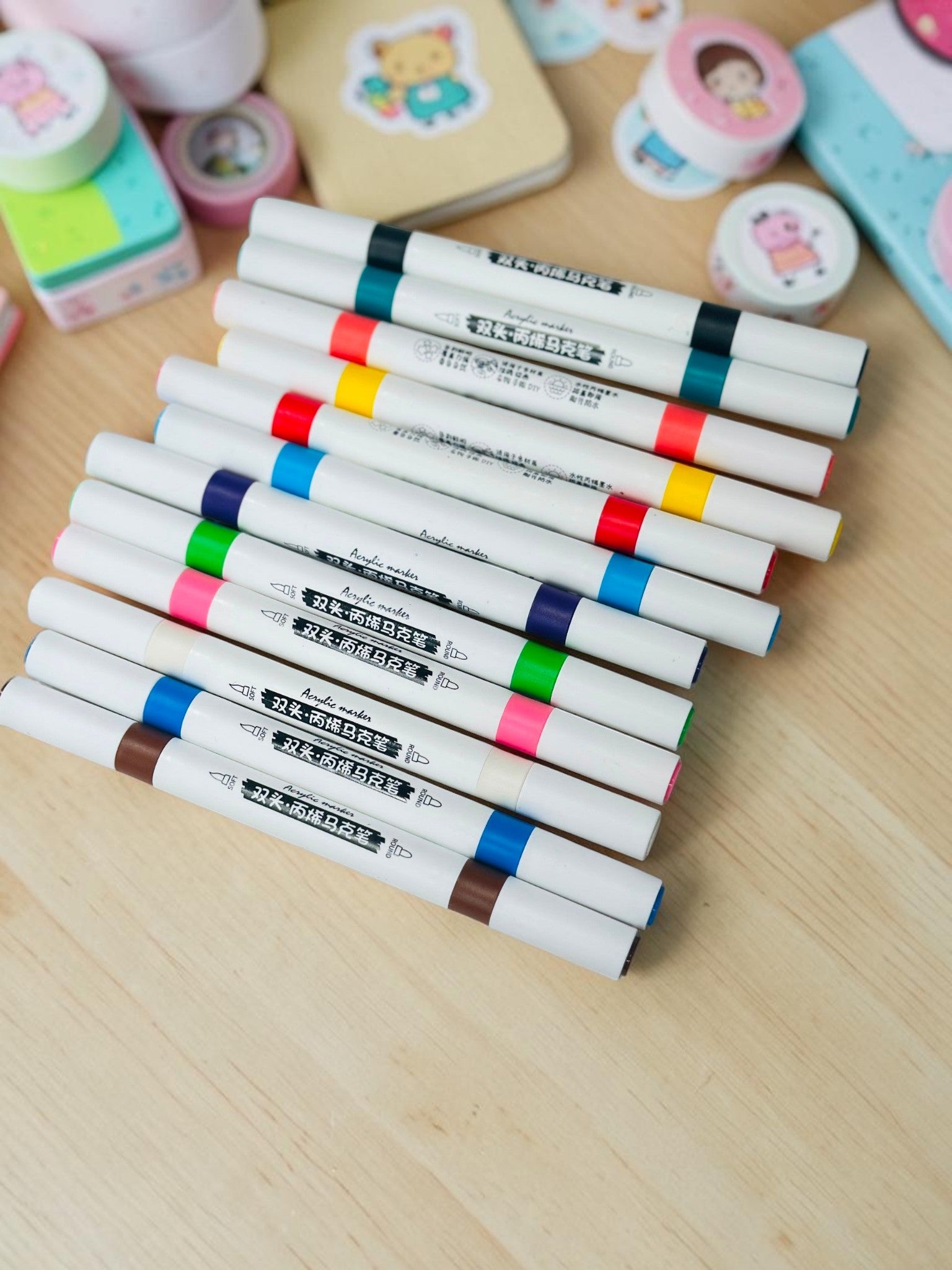 Miso station dual tip acrylic paint markers in a variety of vibrant colors on a white textured background.