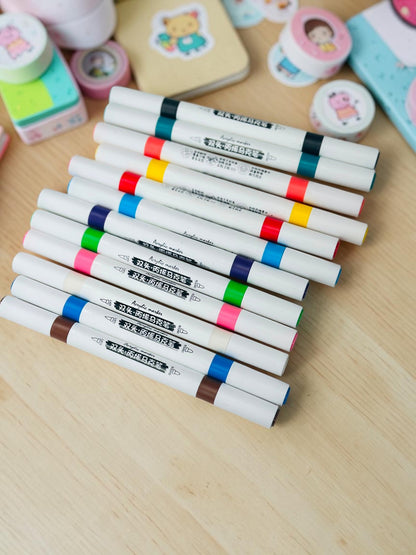 Miso station dual tip acrylic paint markers in a variety of vibrant colors on a white textured background.