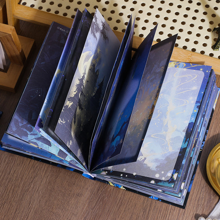 Miso station Whisper of the Forest hardcover journal with open pages showing deep blue fantasy forest illustrations