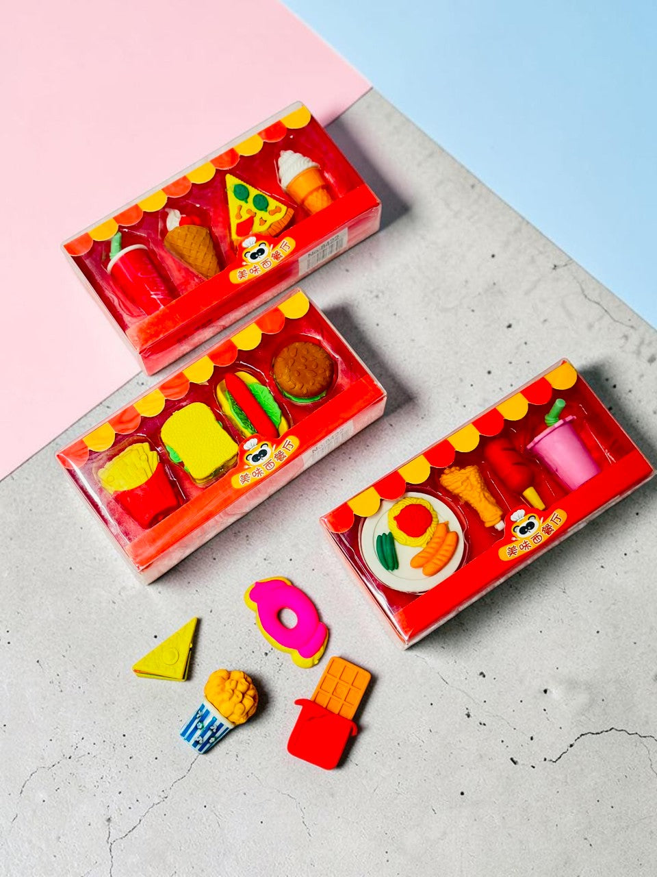 Miso station fast food themed eraser sets including miniature burgers, fries, and desserts in clear display boxes.