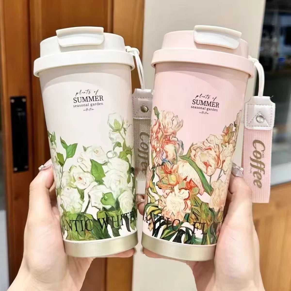 Miso station insulated travel tumblers in white and pink with floral botanical prints and carrying straps.