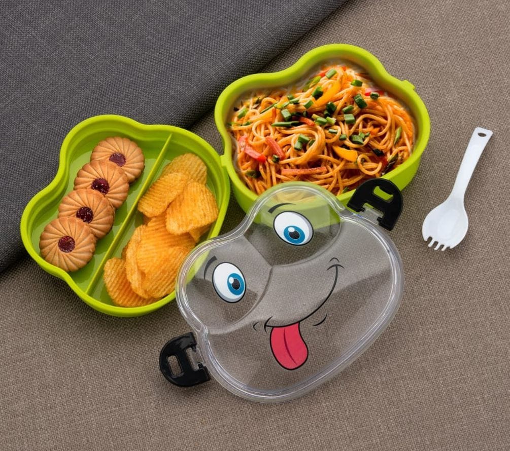 Miso station green character lunch box with two compartments, filled with noodles, cookies, and chips with a spoon.