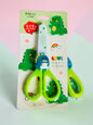 Miso station green dinosaur-themed children's safety scissors with rounded tips and ergonomic handles in packaging.