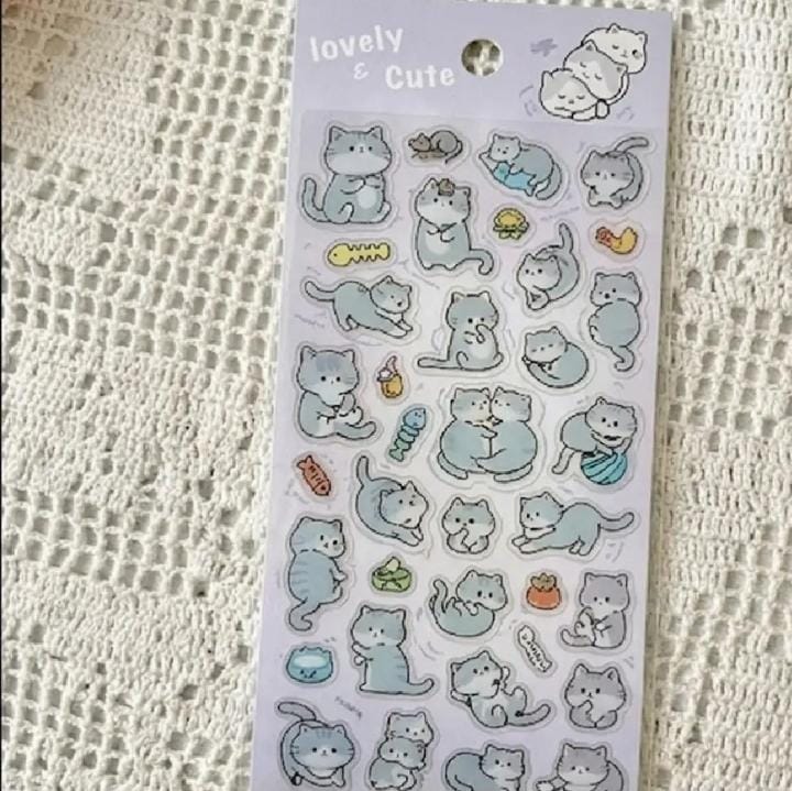 Miso station sticker sheet featuring cute grey cat illustrations in various playful poses on a white lace background