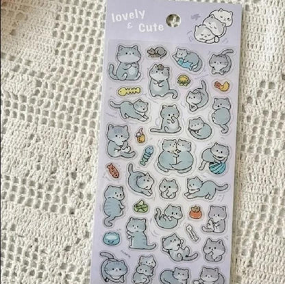 Miso station sticker sheet featuring cute grey cat illustrations in various playful poses on a white lace background