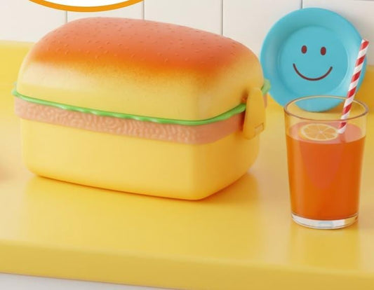 Miso station hamburger shaped bento lunch box with a yellow bun lid and side locking clips on a yellow surface