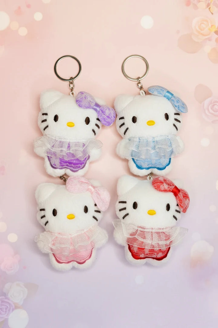 Miso station Hello Kitty plush keychains in white with colorful lace outfits and matching bows on a pink background
