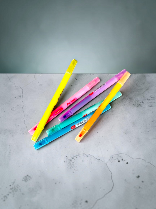 Miso station Fantasy erasable double-headed highlighters in six vibrant fluorescent colors on a grey stone surface.