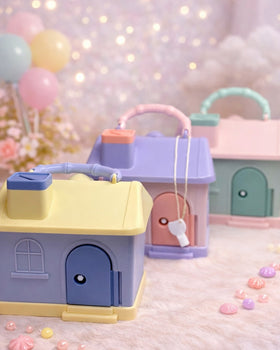 Miso station house-shaped portable piggy banks in pastel yellow, purple, and blue with carrying handles and keys.