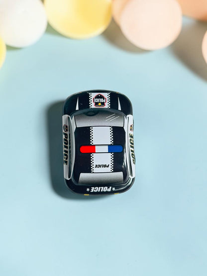 Miso station black and white metal police toy car with red and blue light bar viewed from above on blue background