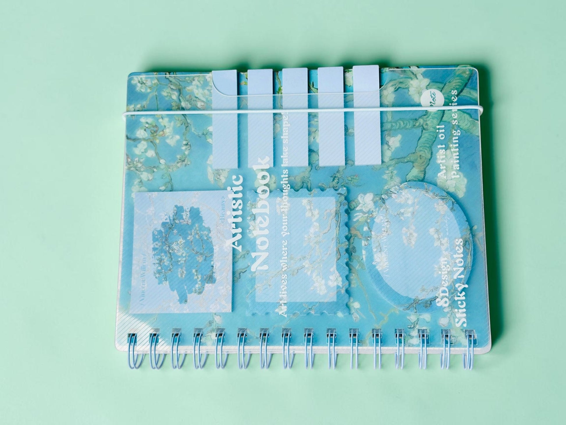 Miso station spiral notebook featuring a blue oil painting cover with integrated sticky notes and page markers.