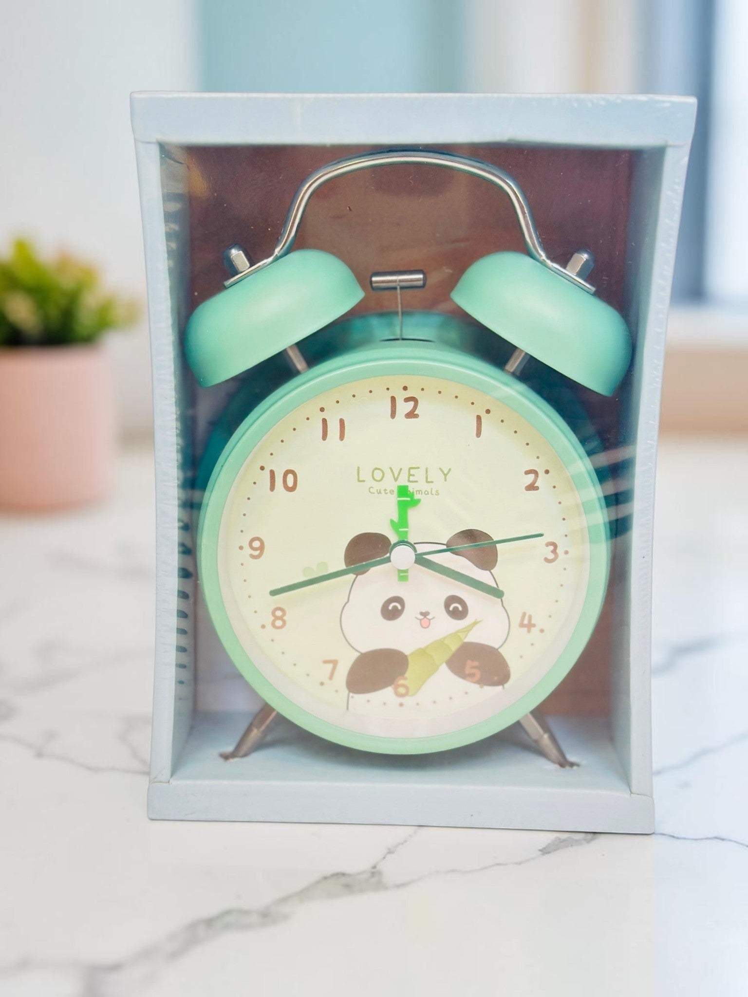 Miso station pastel green twin-bell analog alarm clock featuring a cute panda illustration on the dial in packaging.