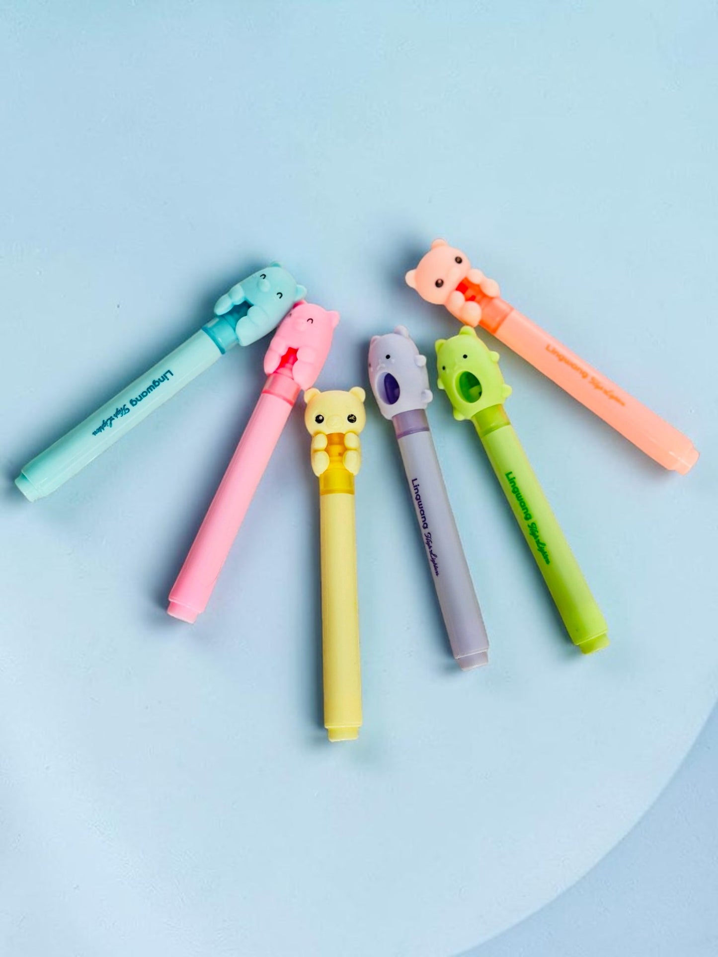 Miso station pastel highlighter pen set with cute 3D animal character caps arranged in a fan shape on white brick